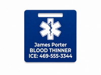 Blue medical alert tag with a star of life symbol and personalized text on a white background
