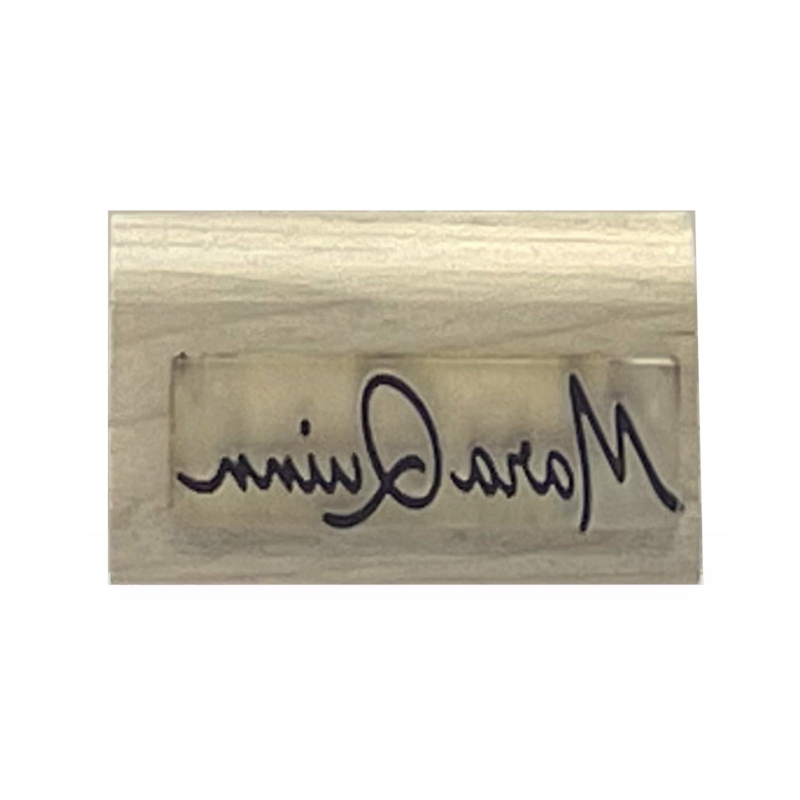 Laser-engraved die face of a custom signature stamp on a maple block