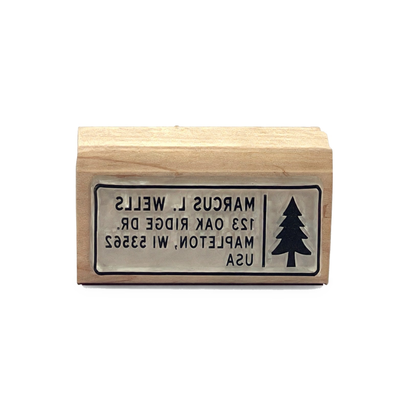 Laser-engraved die face of a custom return address stamp with a tree icon