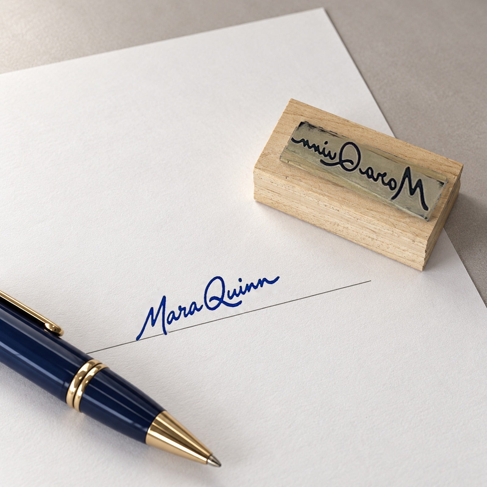 Signature stamped on a document's signature line next to a pen and the signature stamp
