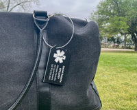 Black bag with a medical alert tag on a grassy background