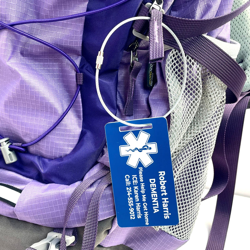 blue dementia medical tag on purple hiking bag
