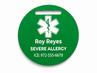 Green medical alert tag with a star of life symbol and personalized text on a white background