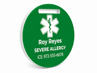 Green medical alert tag with a star of life symbol and personalized text on a white background side angle